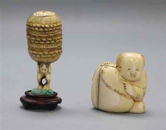 A late 19th century Japanese walrus ivory netsuke of a boy and sack and an ivory netsuke of a man carrying a bale, (579, 581)